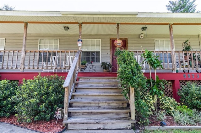 view of exterior entry with covered porch