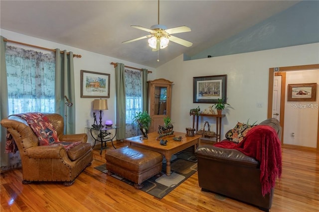 living room with ceiling fan, vaulted ceiling, and light hardwood / wood-style floors