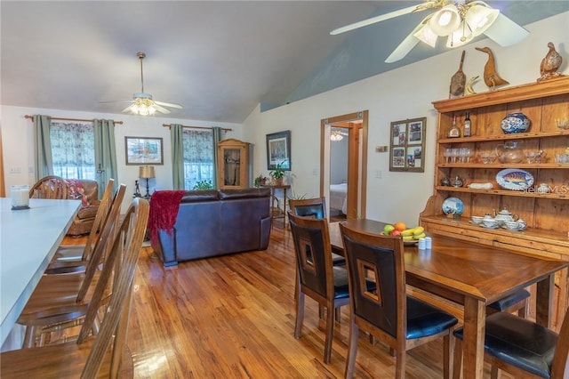 dining space featuring ceiling fan, vaulted ceiling, and light hardwood / wood-style floors