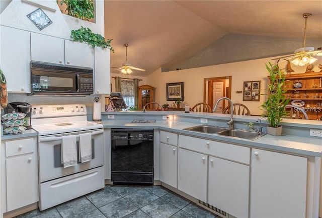 kitchen with ceiling fan, white cabinetry, black appliances, vaulted ceiling with skylight, and sink