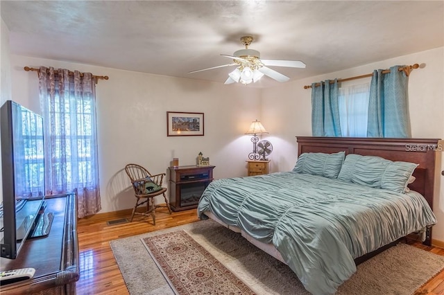 bedroom featuring light hardwood / wood-style flooring and ceiling fan