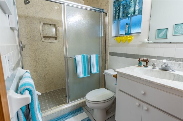 bathroom with tasteful backsplash, toilet, walk in shower, tile patterned floors, and vanity