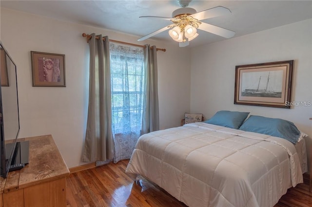 bedroom featuring ceiling fan and hardwood / wood-style flooring