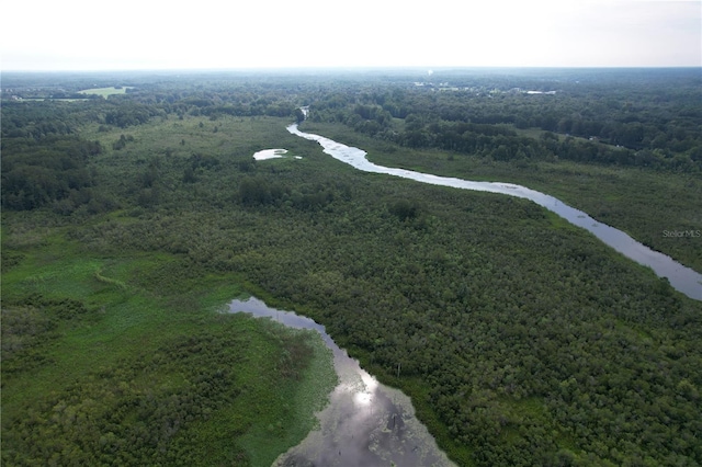 birds eye view of property with a forest view