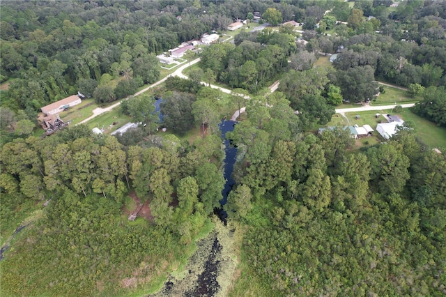 drone / aerial view featuring a wooded view