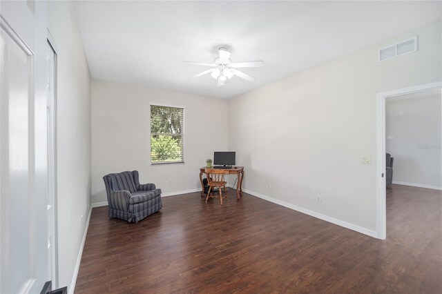 living area with ceiling fan and dark hardwood / wood-style floors