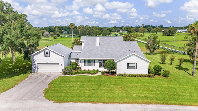 view of front of home featuring a garage and a front lawn