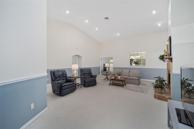 carpeted living room with lofted ceiling