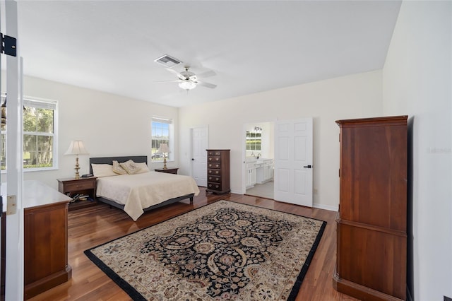 bedroom with ceiling fan, hardwood / wood-style floors, and ensuite bath