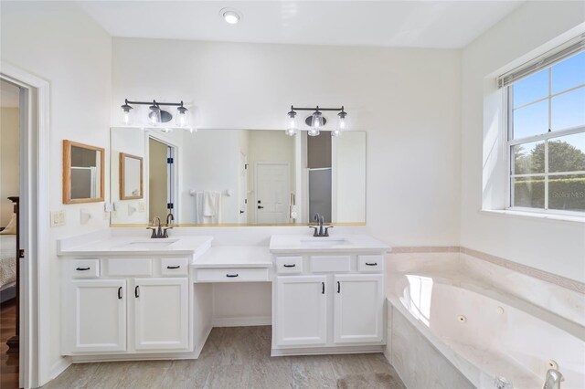 bathroom featuring separate shower and tub and vanity