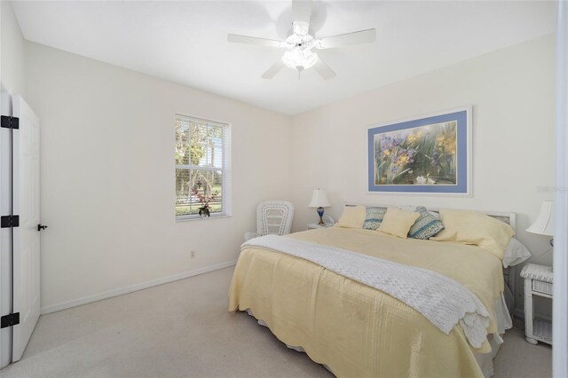 bedroom featuring ceiling fan and light carpet