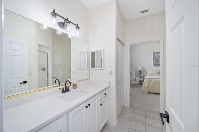 bathroom featuring tile patterned flooring and vanity