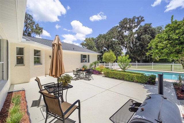 view of patio featuring a fenced in pool