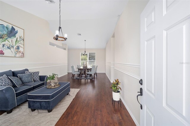 living room with a chandelier and wood-type flooring