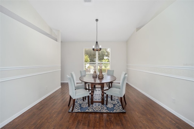 dining room with lofted ceiling, a notable chandelier, and dark hardwood / wood-style flooring