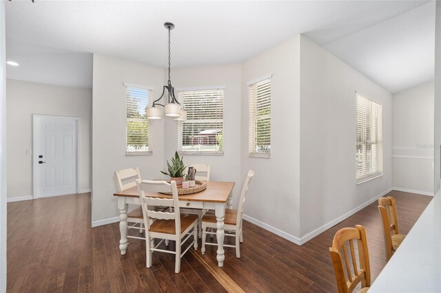 dining space with plenty of natural light, dark hardwood / wood-style floors, and a chandelier