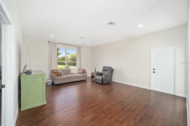 sitting room with dark wood-type flooring