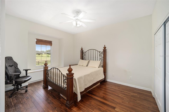 bedroom with ceiling fan, a closet, and dark wood-type flooring