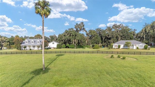 view of yard featuring a rural view and fence