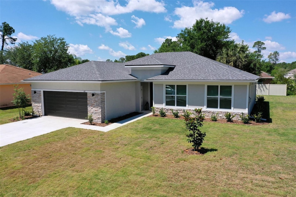 view of front facade with a garage and a front lawn