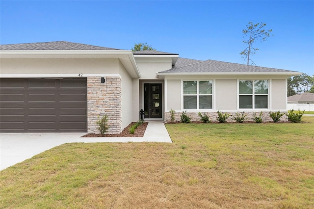 view of front of house with a garage and a front yard