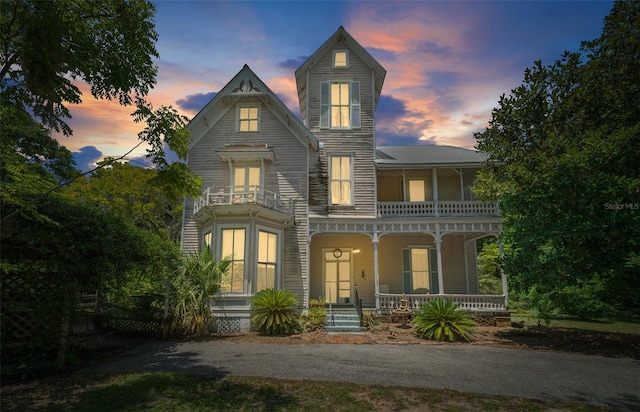 view of front of house with a balcony and a porch