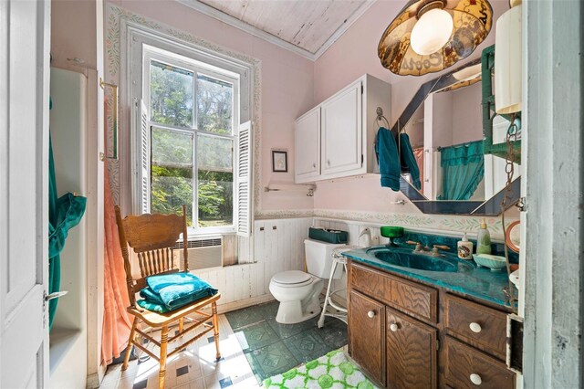 bathroom with vanity, toilet, a wealth of natural light, and crown molding