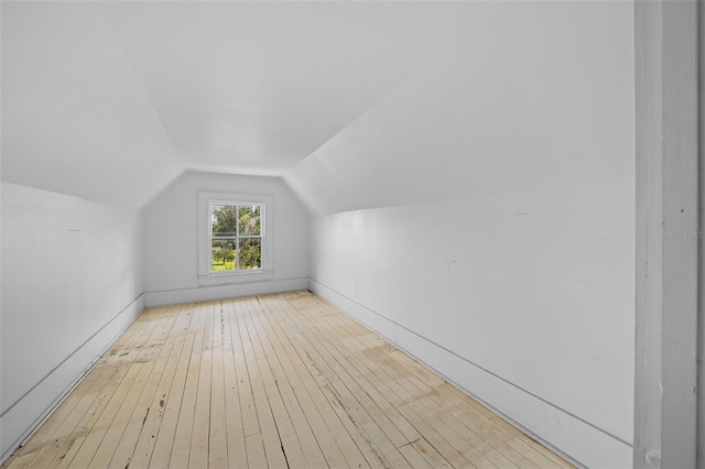 bonus room featuring vaulted ceiling and light wood-type flooring