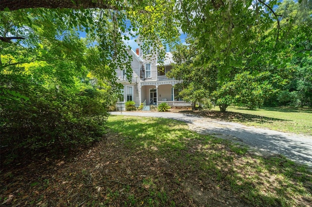 view of front of home with a porch and a front yard