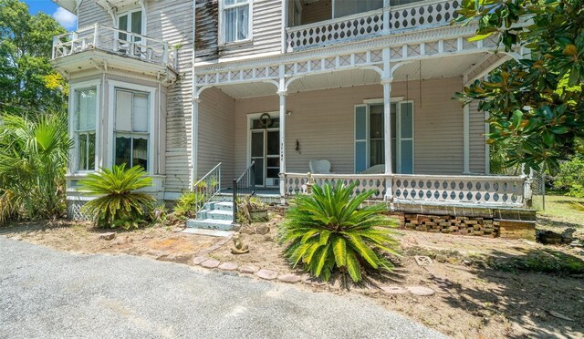 property entrance with a balcony and covered porch