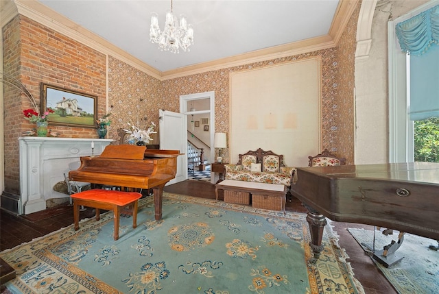 living area featuring brick wall, wood-type flooring, ornamental molding, and a notable chandelier