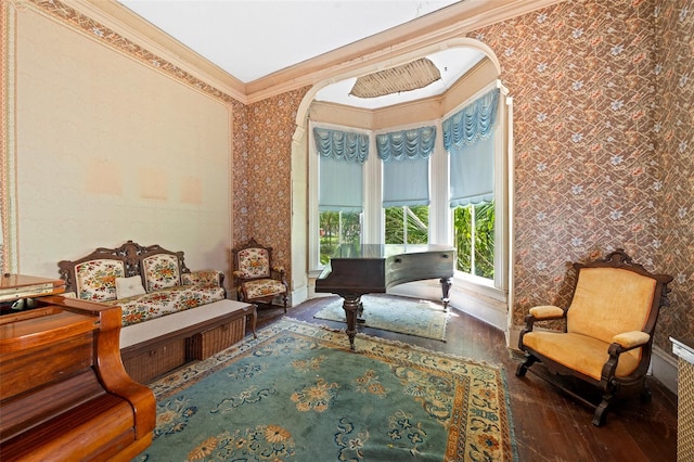 sitting room with hardwood / wood-style flooring and crown molding