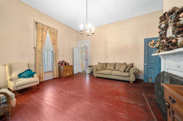 living room with dark hardwood / wood-style flooring and a chandelier