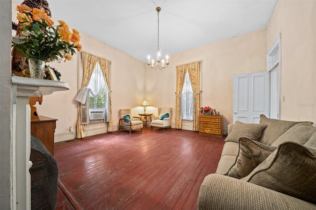 living room featuring a notable chandelier, wood-type flooring, and cooling unit