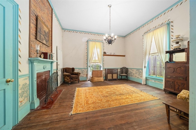 sitting room featuring an inviting chandelier and dark hardwood / wood-style floors