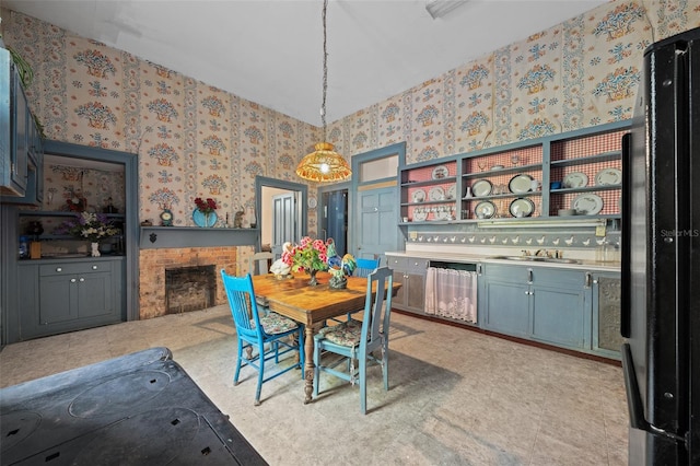 dining space with light tile patterned flooring, a brick fireplace, sink, and a high ceiling