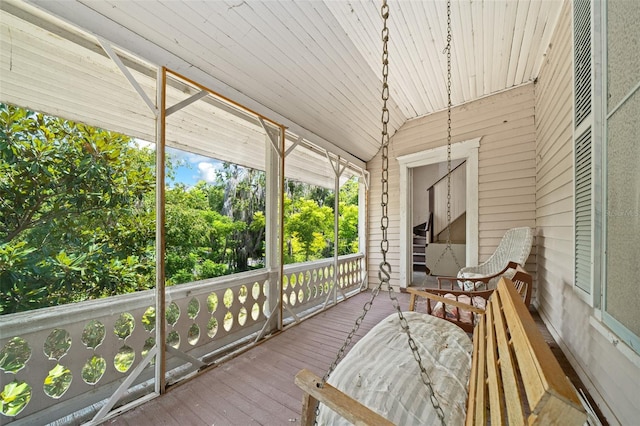 unfurnished sunroom featuring vaulted ceiling and wood ceiling