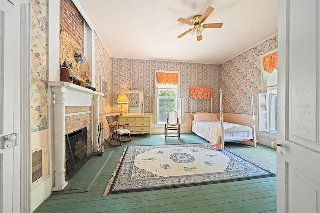 bedroom featuring brick wall, hardwood / wood-style flooring, and ceiling fan