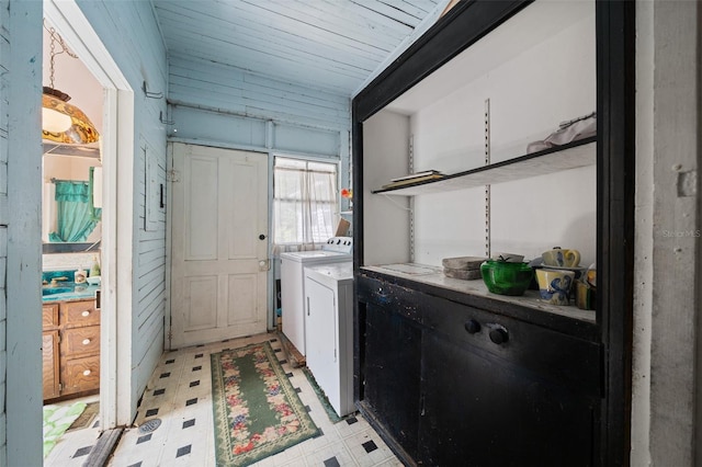 laundry room with washing machine and dryer and light tile patterned floors