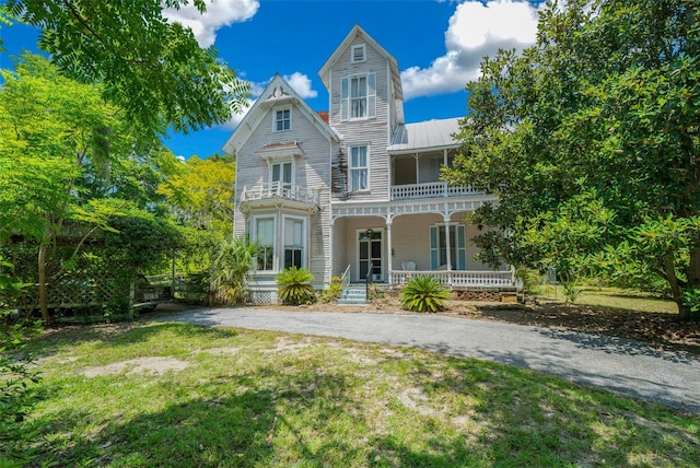 victorian-style house with a balcony and a porch