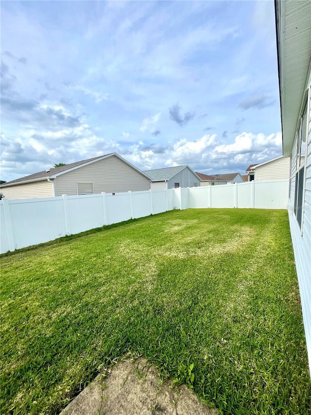 view of yard with a fenced backyard