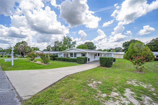 ranch-style home featuring a front yard and a carport