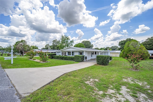 ranch-style home featuring driveway and a front yard