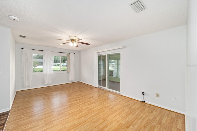 unfurnished room with light hardwood / wood-style floors, a textured ceiling, and ceiling fan