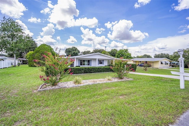 single story home featuring a front lawn