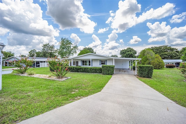 ranch-style home featuring a front lawn and a carport