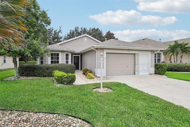 ranch-style home featuring a garage and a front yard