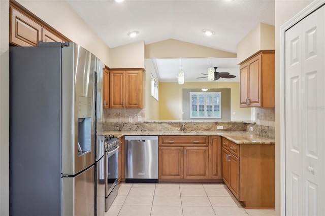 kitchen with backsplash, appliances with stainless steel finishes, light stone counters, ceiling fan, and kitchen peninsula