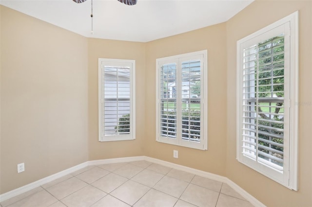 tiled spare room with a healthy amount of sunlight