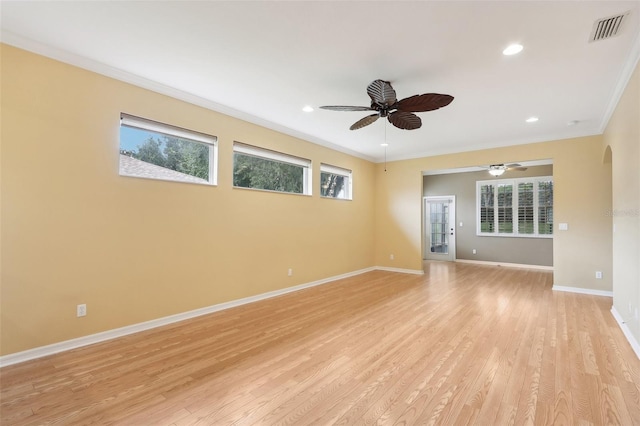 spare room featuring light hardwood / wood-style floors, crown molding, and ceiling fan